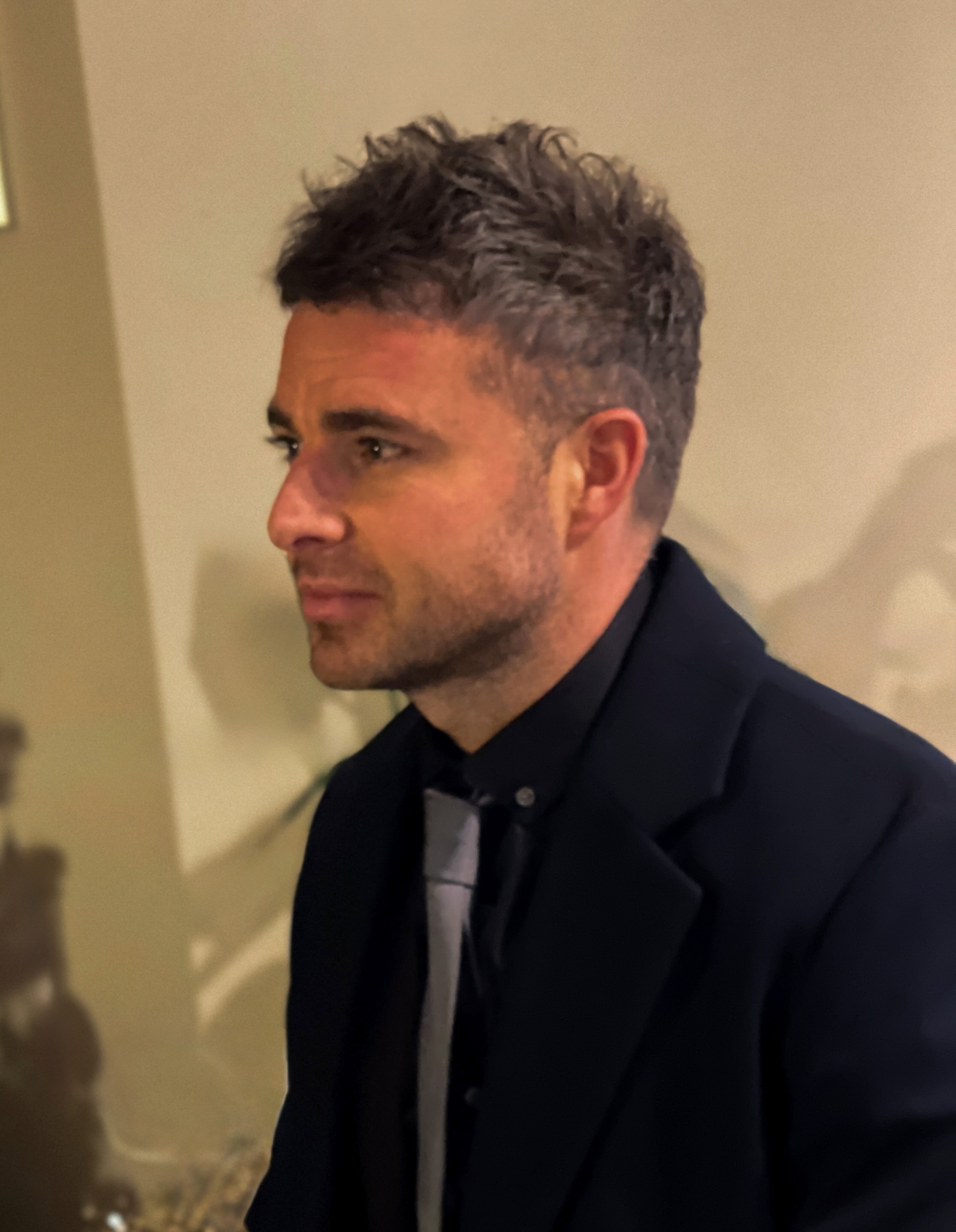Stephen Mantle portrait in a dark suit, used as the personal image for the about page.
